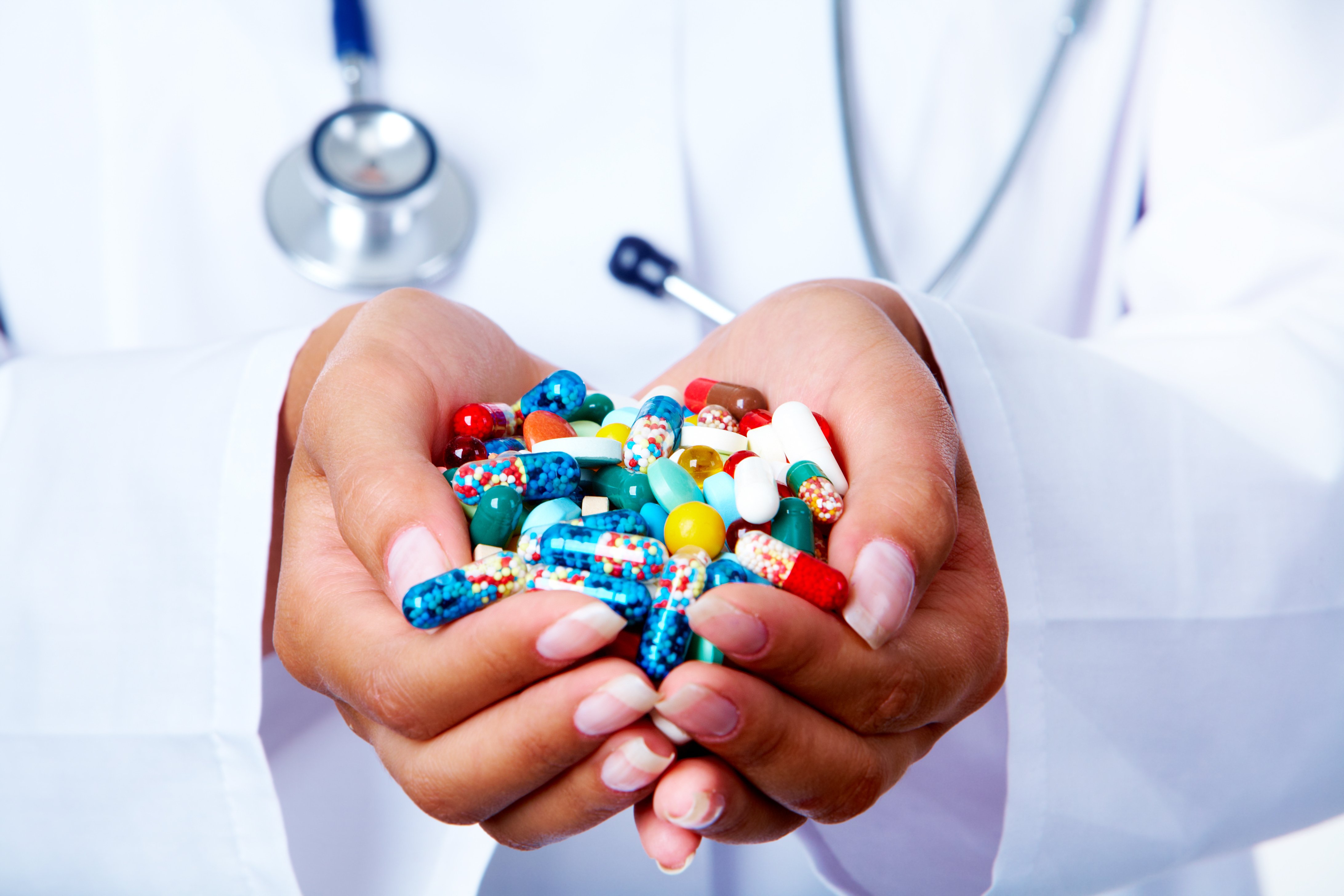 close-up-of-vitamins-and-pills-in-human-hands-SBI-300905791
